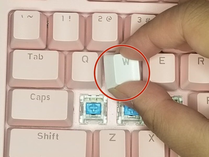 New keycap aligned over the switch stem before pressing down